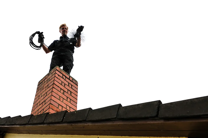 a worker cleans up blockage inside the chimney